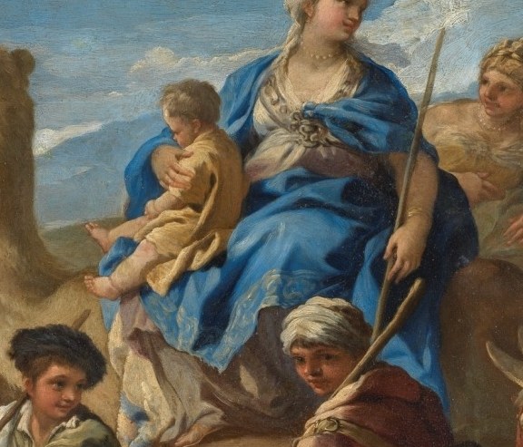 A woman holds her child on a cart.