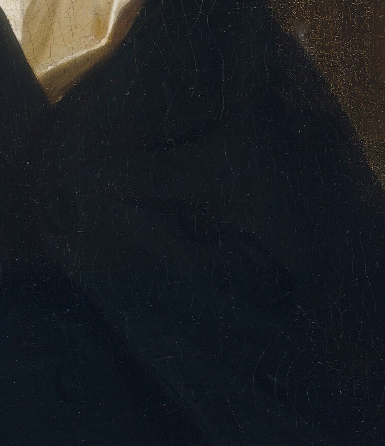 His relaxed hand resting on the chair arm conveys a sense of ease and self-possession.