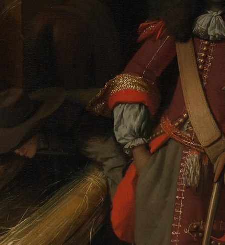 Its wearer is an officer, his sword hilt visible at his hip.