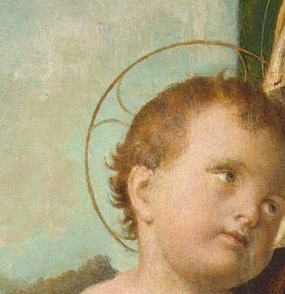 The child looks up, curious and innocent.