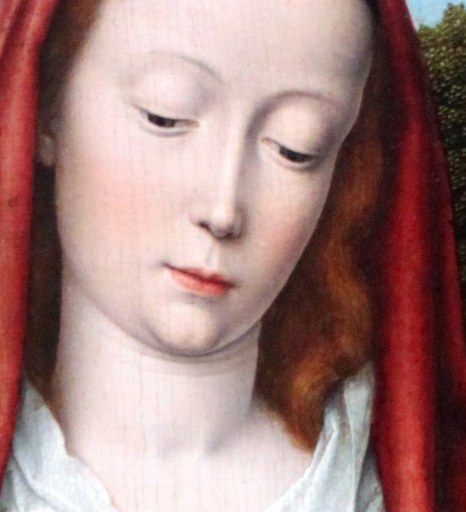 Her serene, downward gaze conveys a tender maternal love and spiritual devotion.