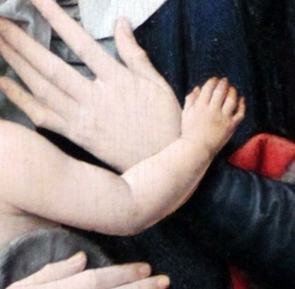 Look at her hands holding the child.