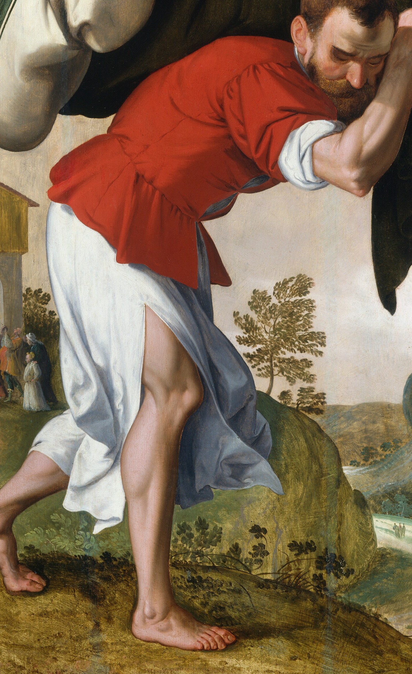 It shows a man carrying another through a rugged landscape.