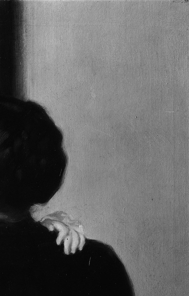 The void is not empty , it absorbs the mother and presses meaning onto the lit child by contrast; a deliberate suppression of domestic setting.