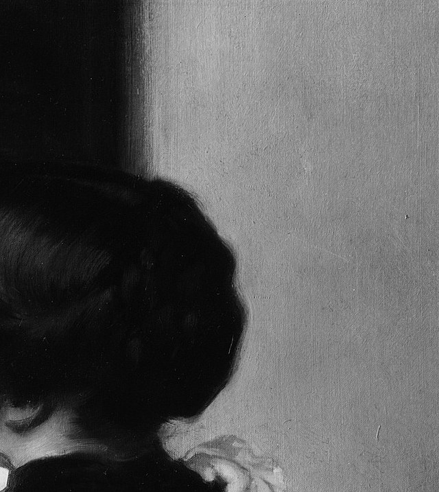 Her face barely registers, a ghost of concern at the edge of the dark.
