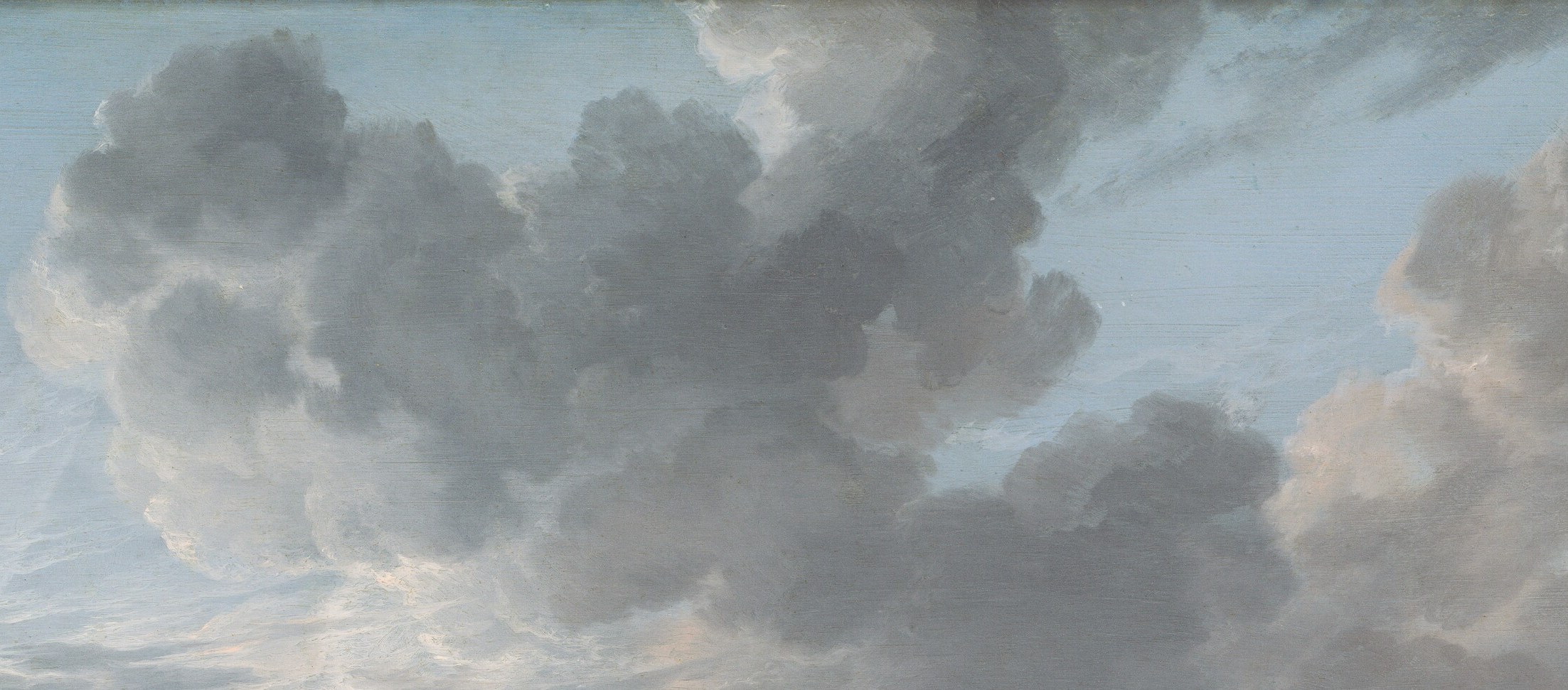 The sky above is full of dramatic, dense gray clouds.