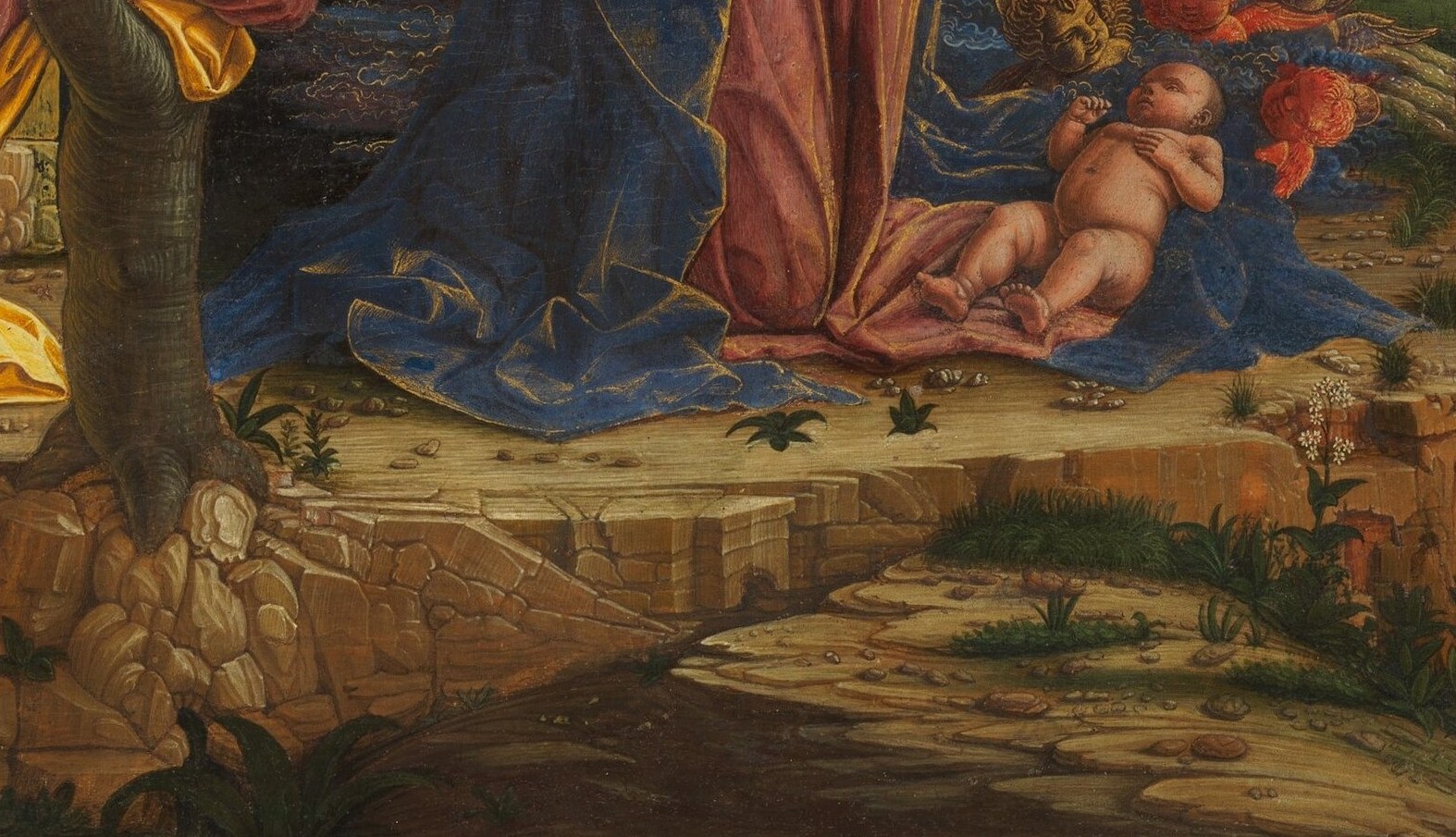 The theological focus of the entire composition; the blue cloth echoes Mary's mantle, creating a sacred visual zone that separates the divine child from bare earth