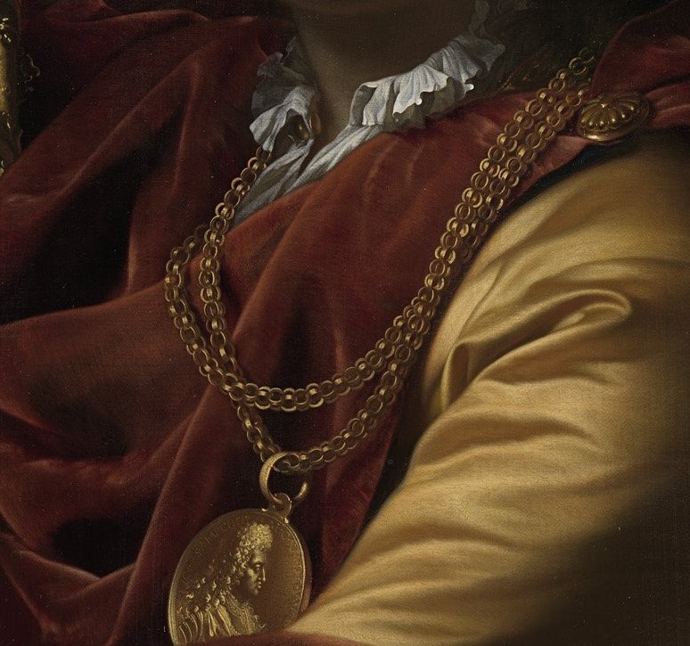 A prominent golden chain shows his professional achievement.