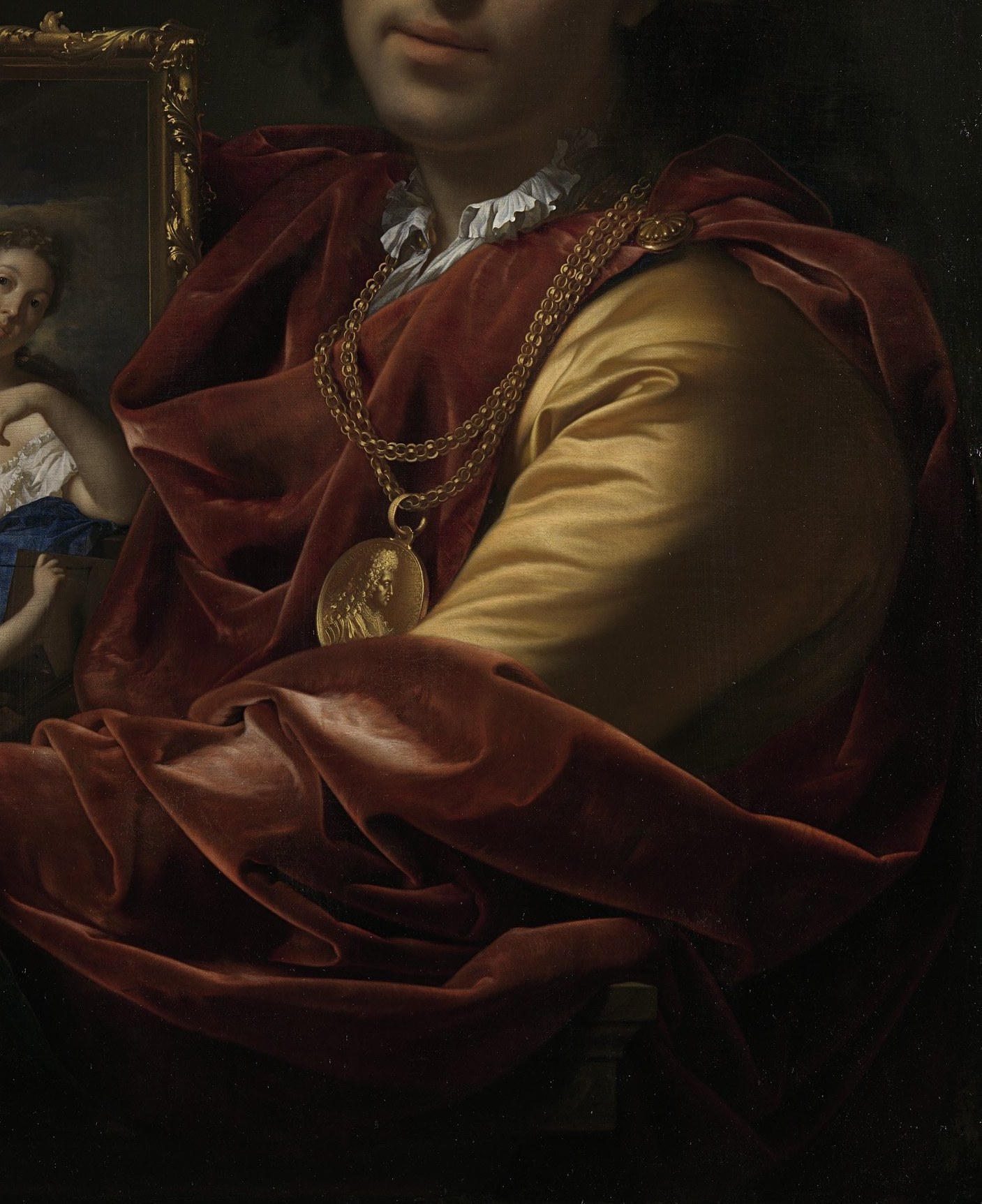 His opulent red robe signals his wealth and status.