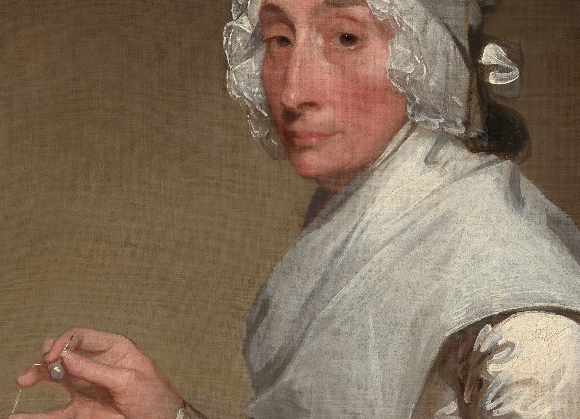 Her dress is white muslin, the neoclassical silhouette of the new republic.