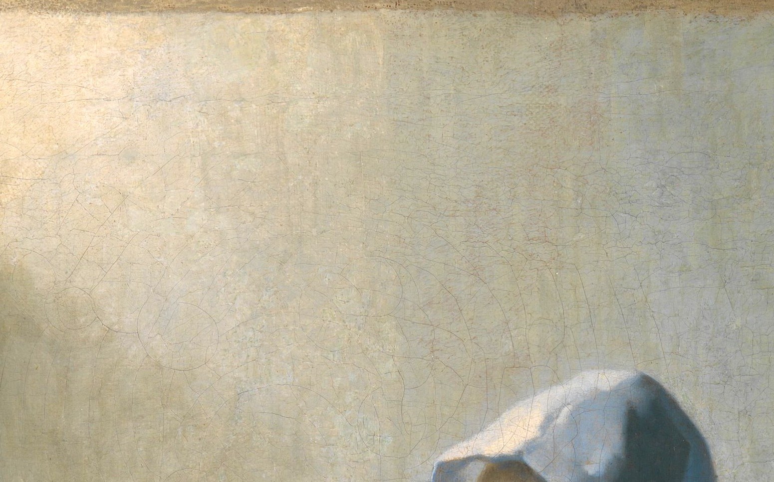 The brilliantly lit white cap anchors the composition's light , Vermeer uses it as a reflective plane to model the face in the surrounding cool warmth.