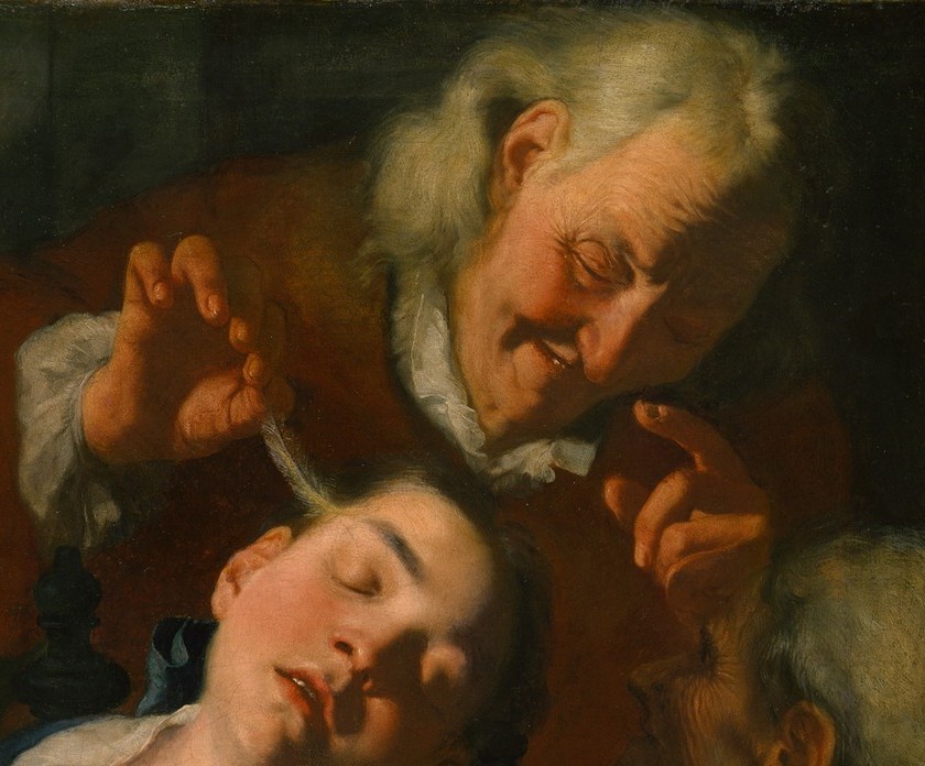 His forward lean and likely whispering or pointing posture signals the instigator of the teasing; the age contrast with the young sleeper heightens the social ambiguity