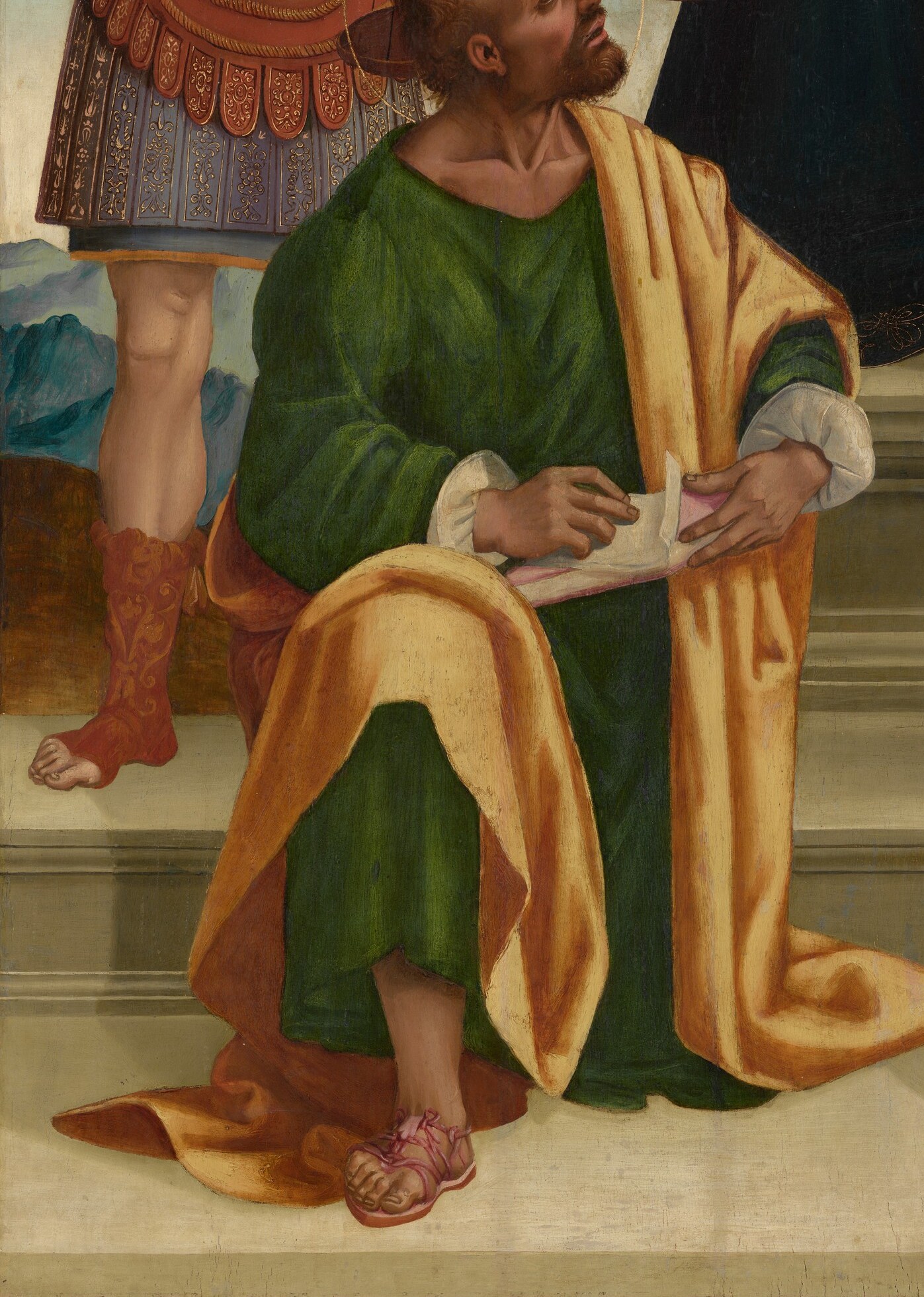 Likely an Evangelist or Doctor of the Church; his concentrated downward attention on a text contrasts with the celestial figures above, grounding scripture in the scene.