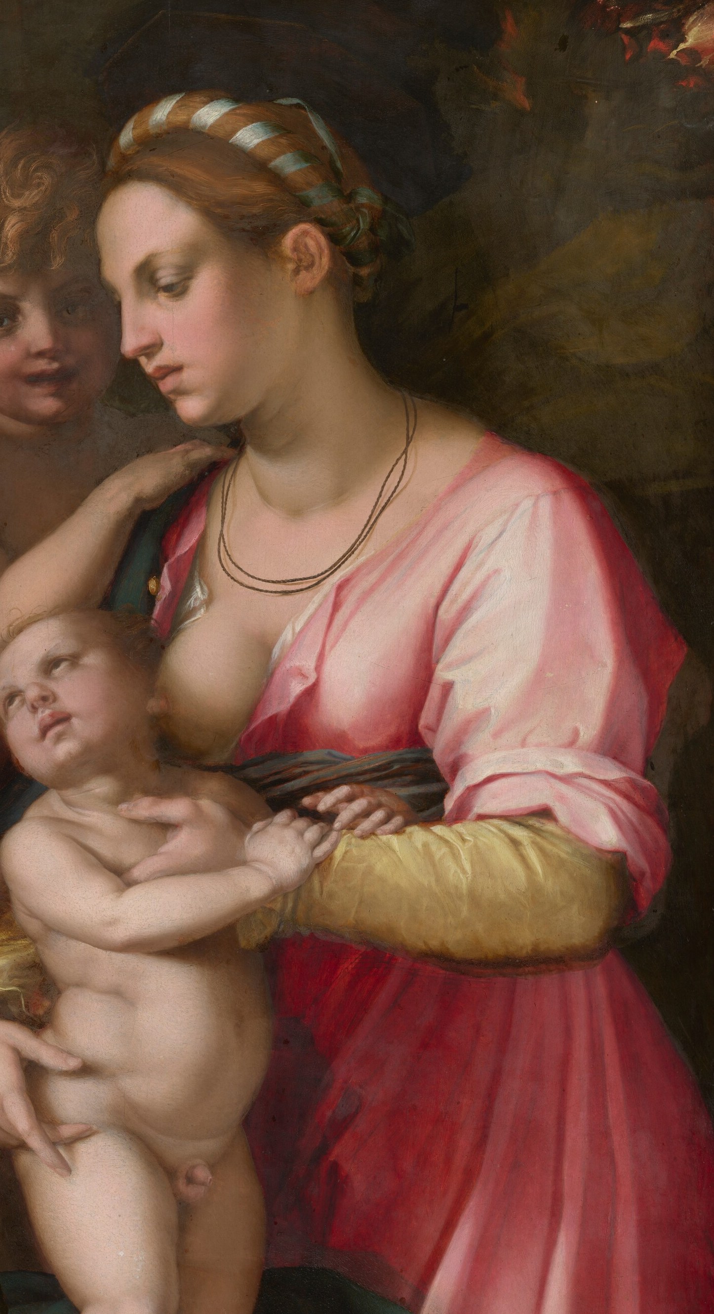 Her serene expression and downward gaze suggest contemplation and maternal devotion.
