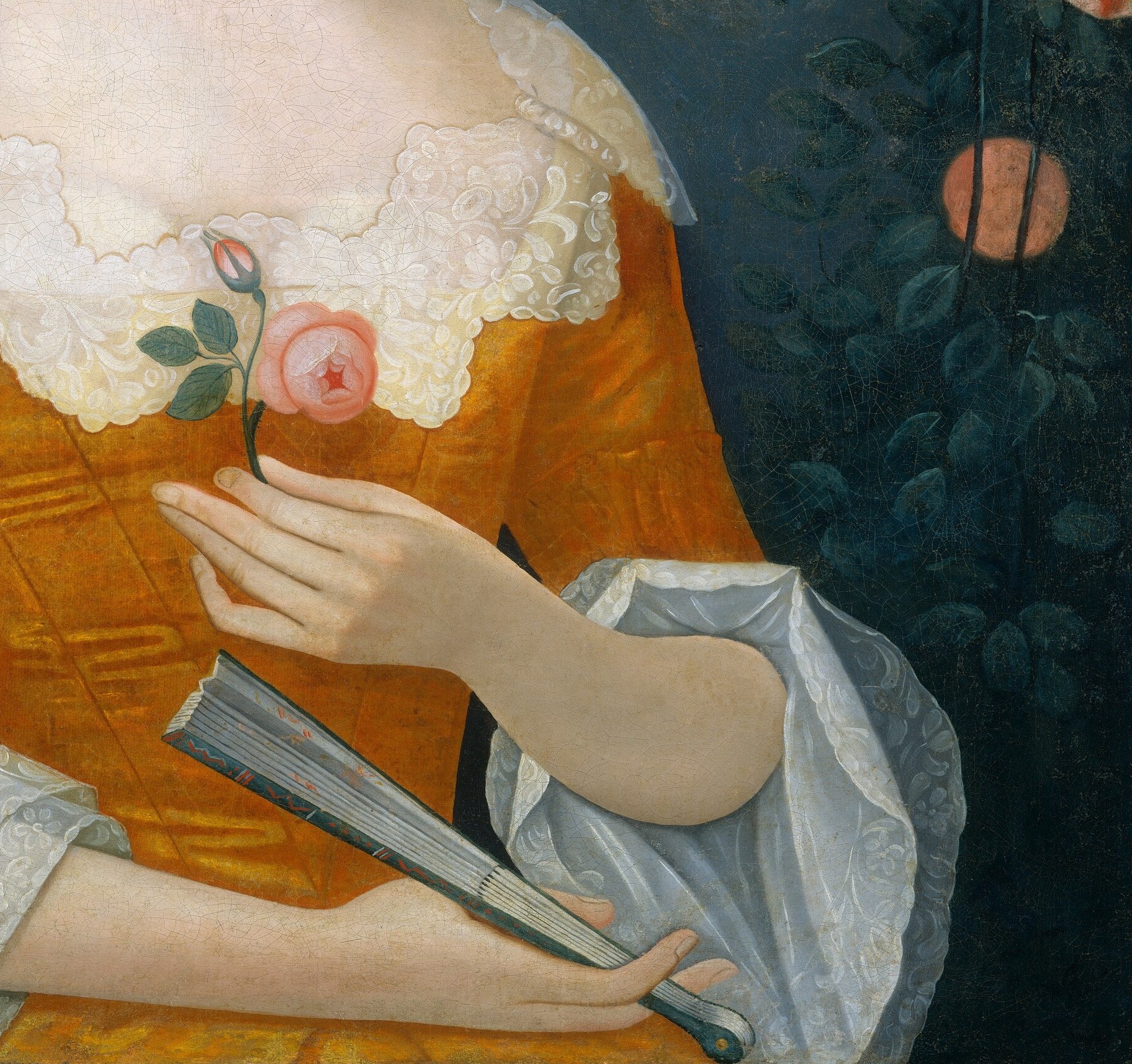 Her ornate yellow dress speaks of wealth and fashion.