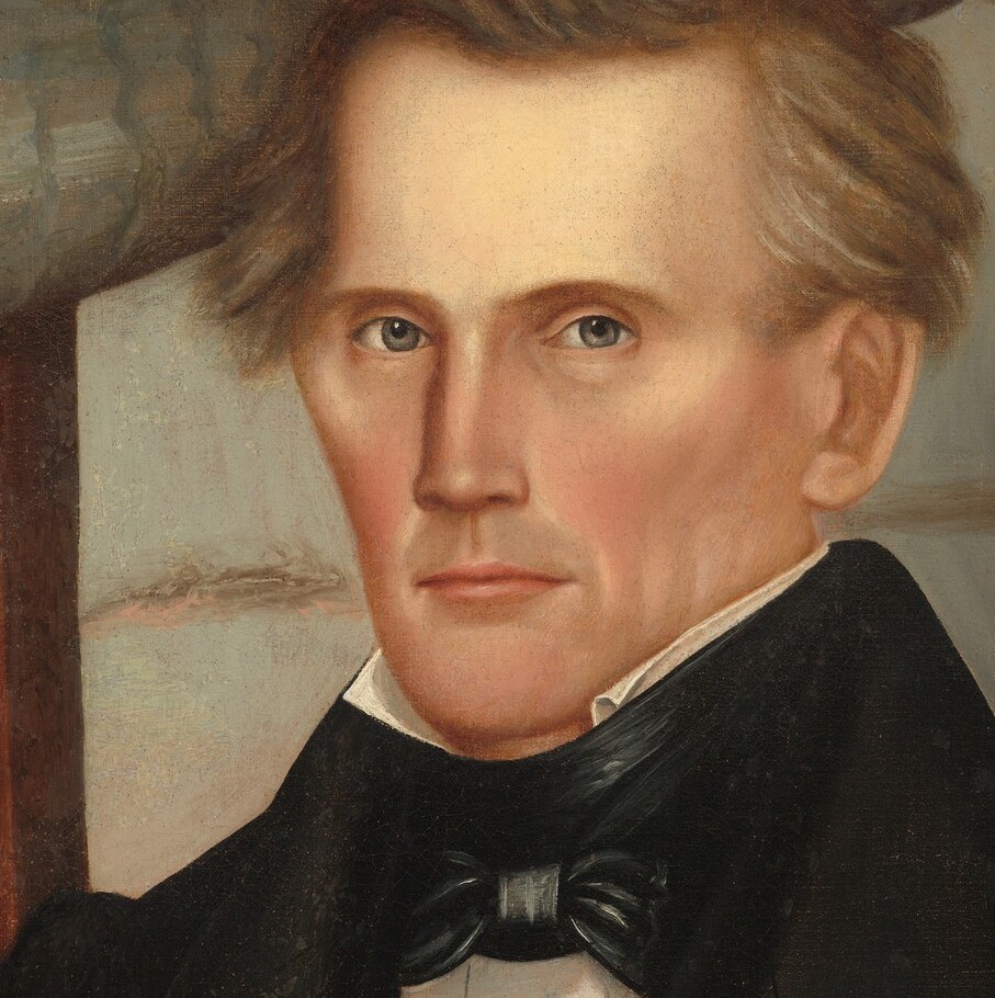 His direct gaze and slightly furrowed brow suggest deep thought or perhaps a hint of weariness.