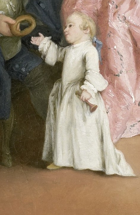 Now find the child in white, near the edge of the frame.