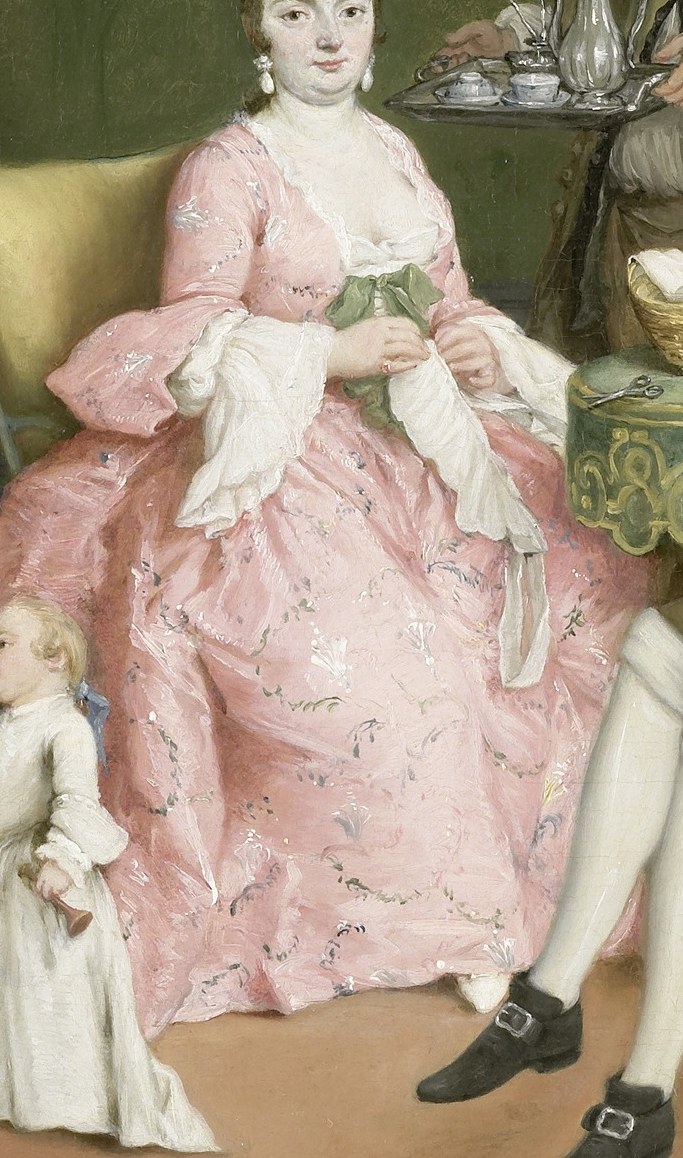 A mother in pink silk cradles her infant.