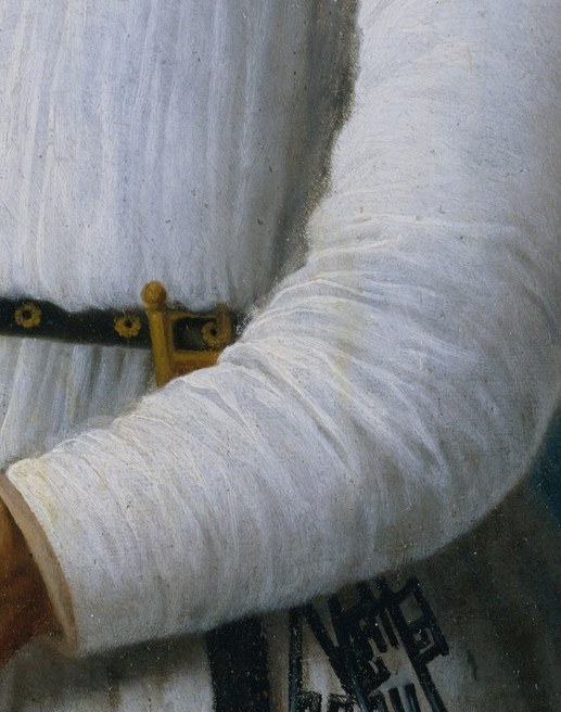 His left hand grips a surgical tool beside the bone.