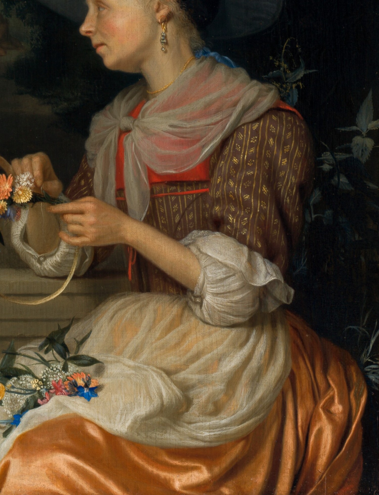 This woman weaves a crown of flowers, a common scene.