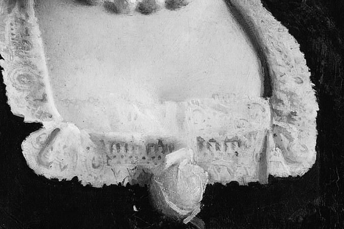The delicate lace collar highlights her formal attire.