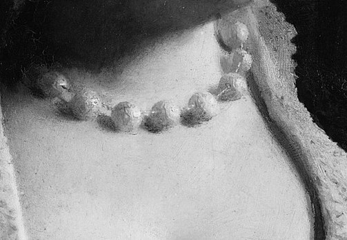 Her pearl necklace adds a touch of subtle wealth and elegance.