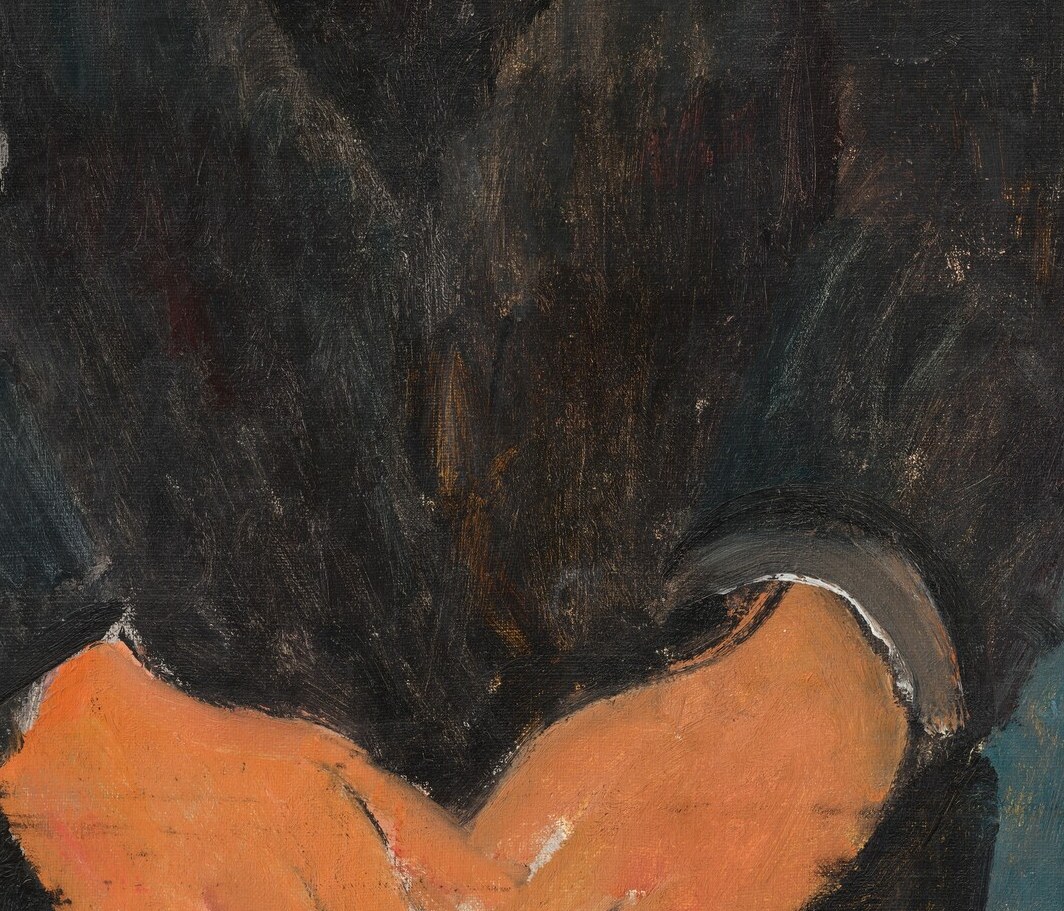 Notice the hands, clasped in quiet composure.