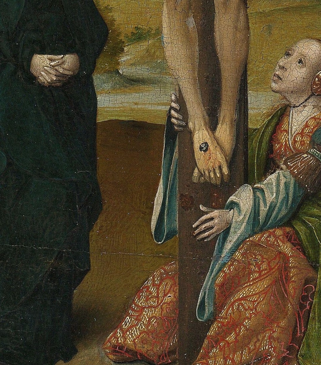 Notice Mary Magdalen, embracing the cross with fervent devotion.