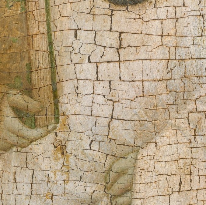 Cradled in his hands, the monastic rule he wrote.