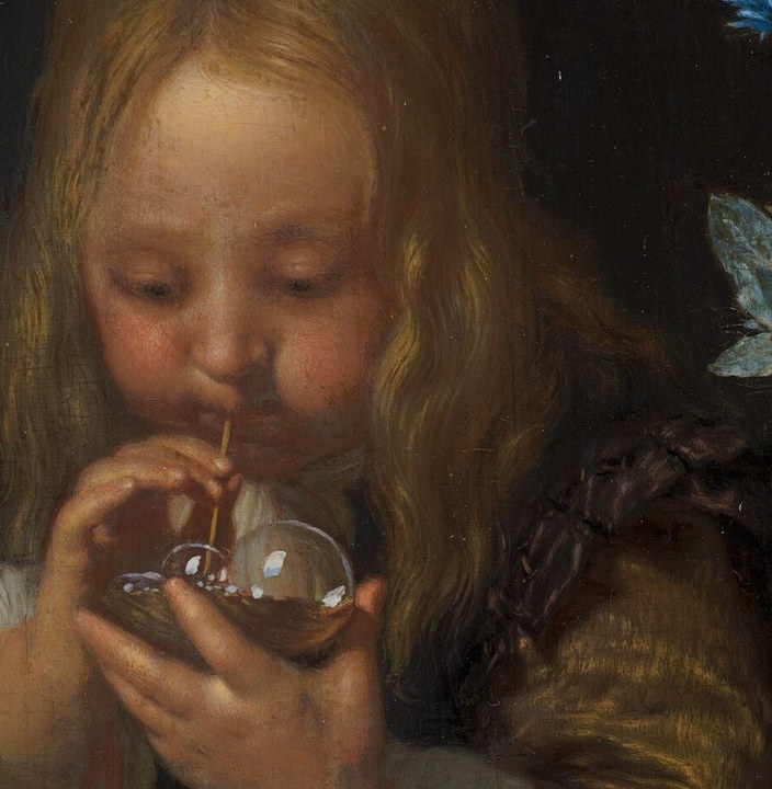 Here, a boy concentrates on blowing a delicate bubble.