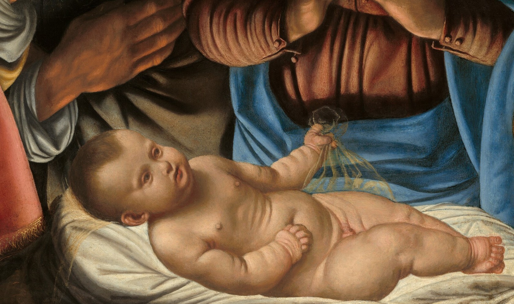 He illuminates the figures using light from the Christ Child.