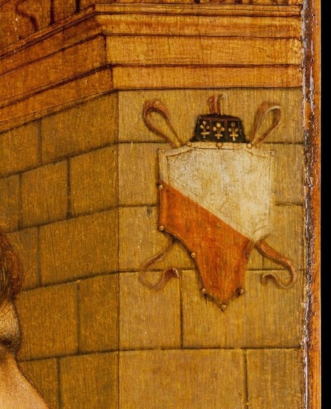 Carved into the stone: a family coat of arms, still legible after five centuries.