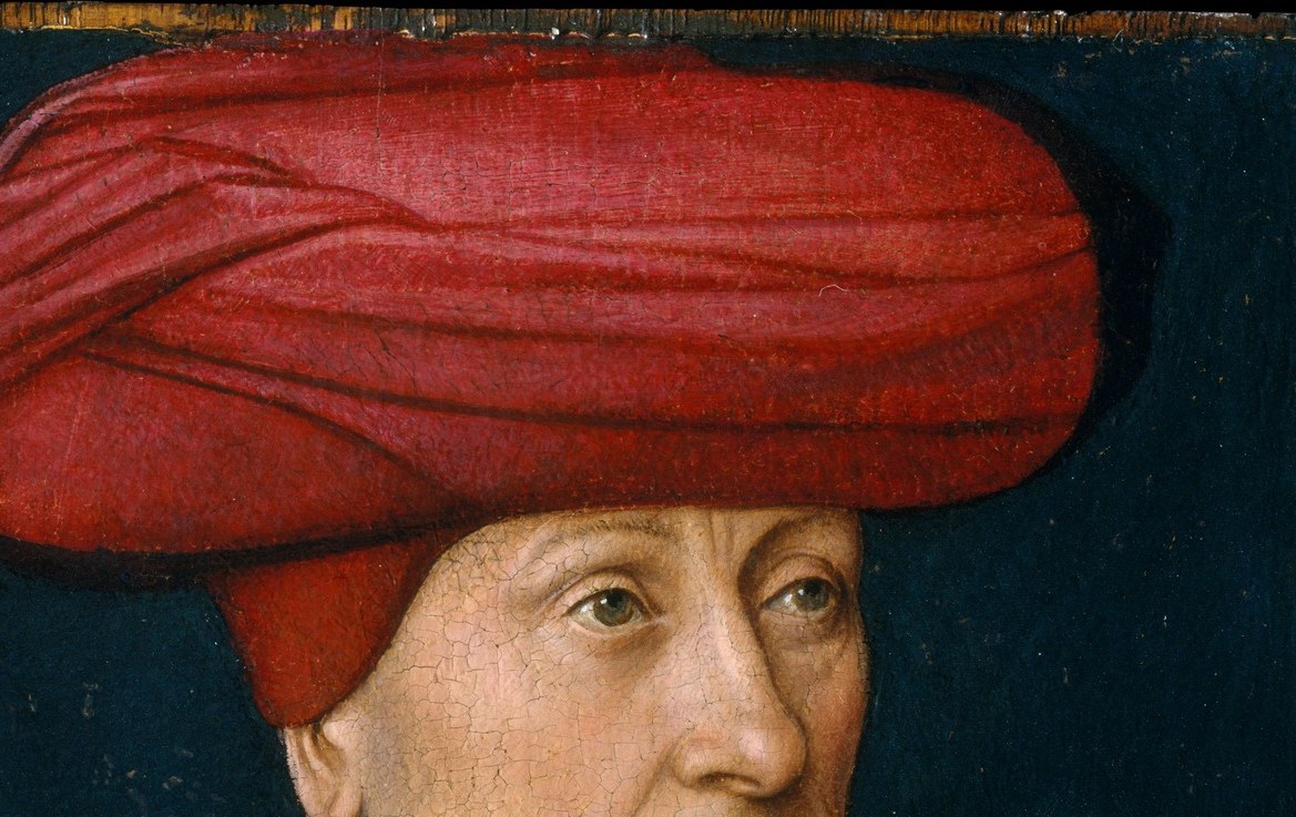 The voluminous crimson turban dominates the upper canvas; its elaborate folded fabric displays Christus's virtuoso rendering of textile while simultaneously signaling wealth and possibly exotic or mercantile associations.