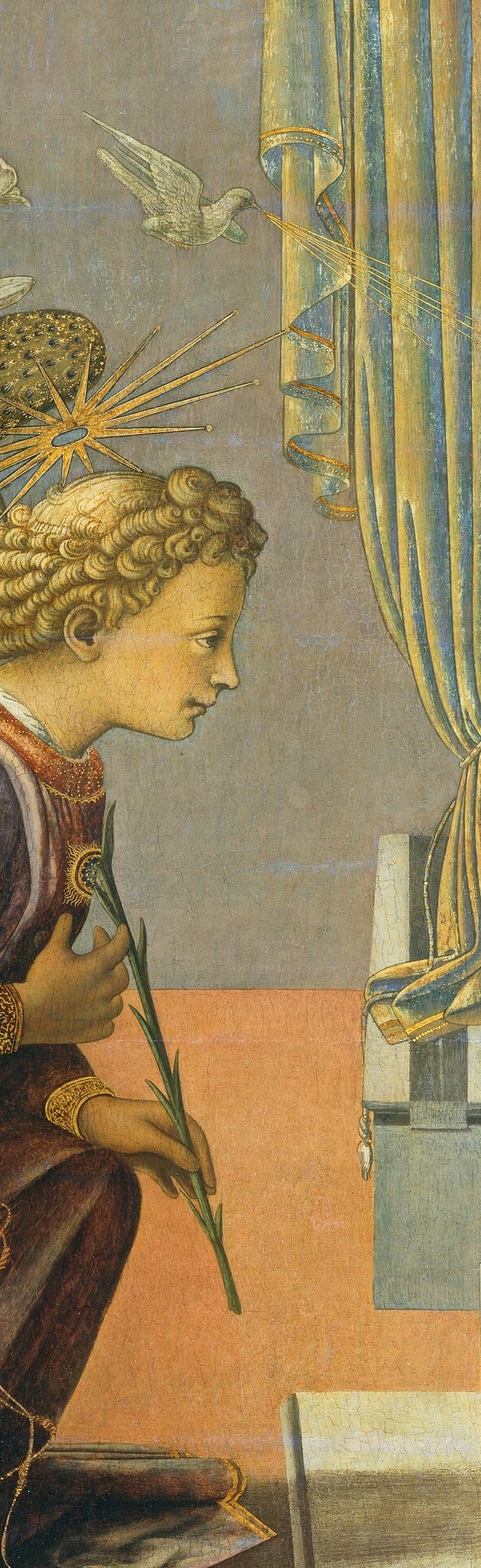 He holds a lily, a symbol of Mary's purity.
