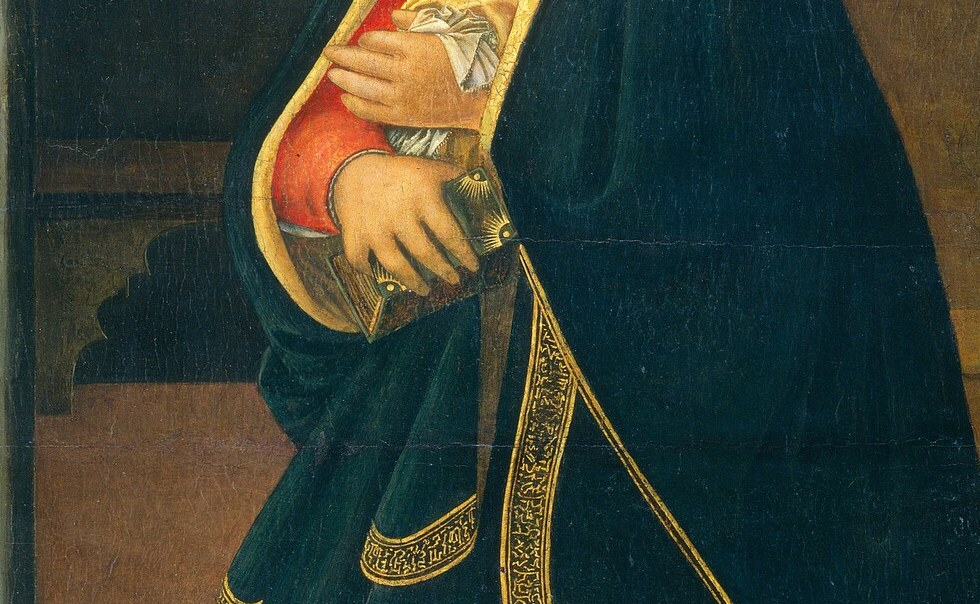 Mary's crossed hands signify humble acceptance.