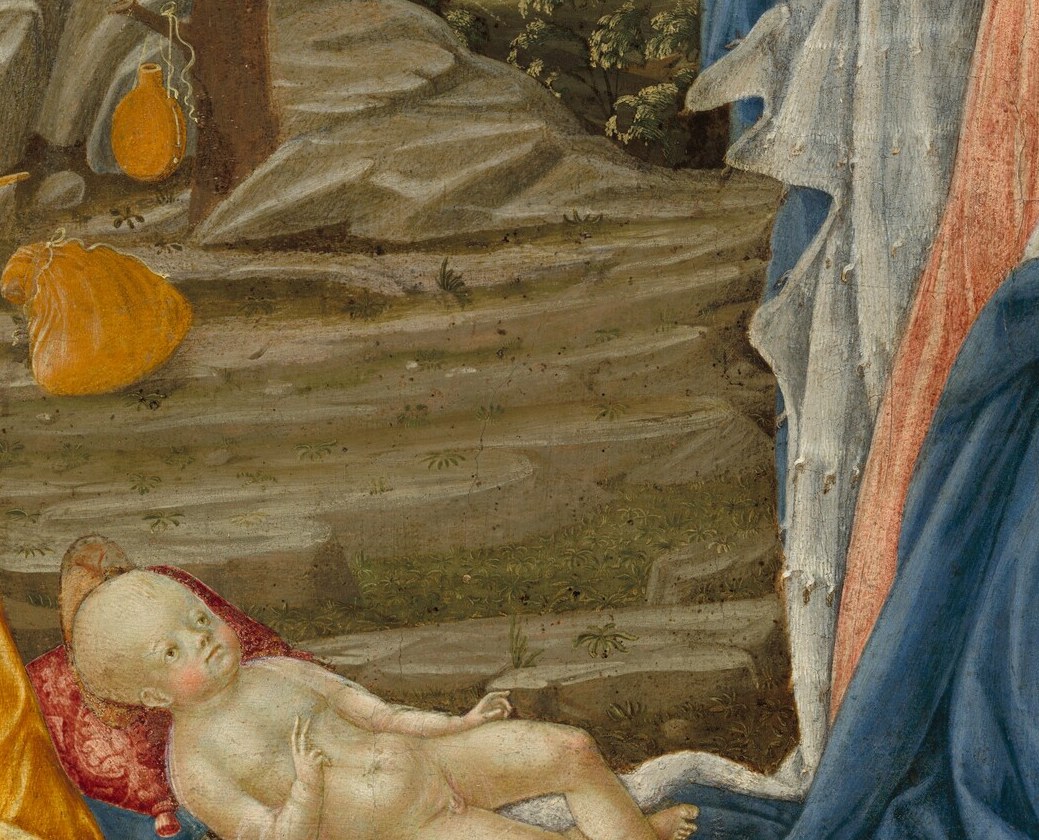 The Christ Child lies on bare ground, a symbol of humility.