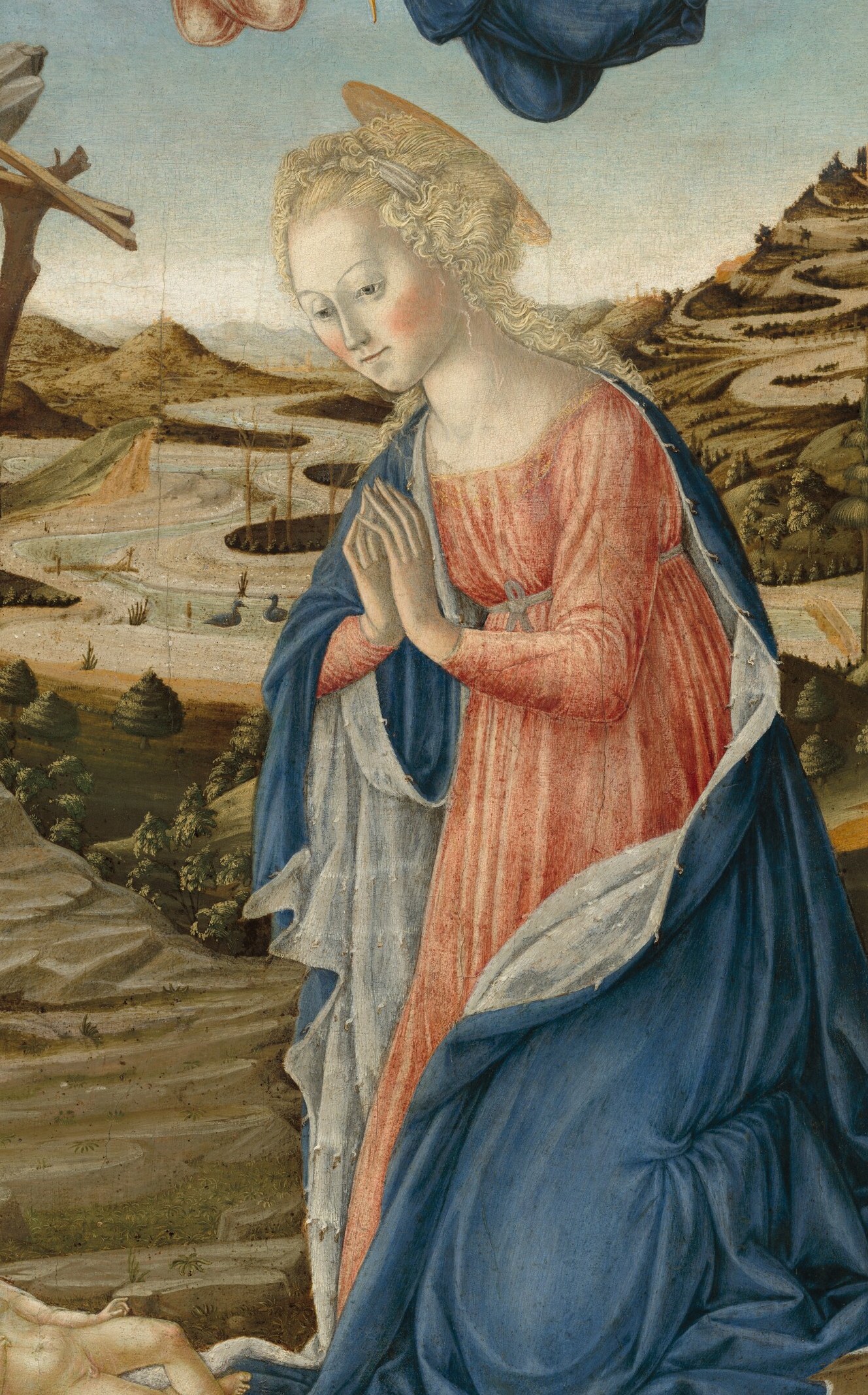 Mary kneels in worship, not cradling her child.