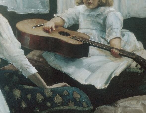 A guitar rests across a child's lap.