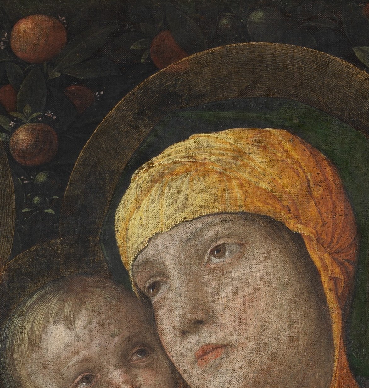 Her tilted head and lidded eyes project tender melancholy; the gold veil frames the face like a halo substitute, making it the emotional anchor of the composition.
