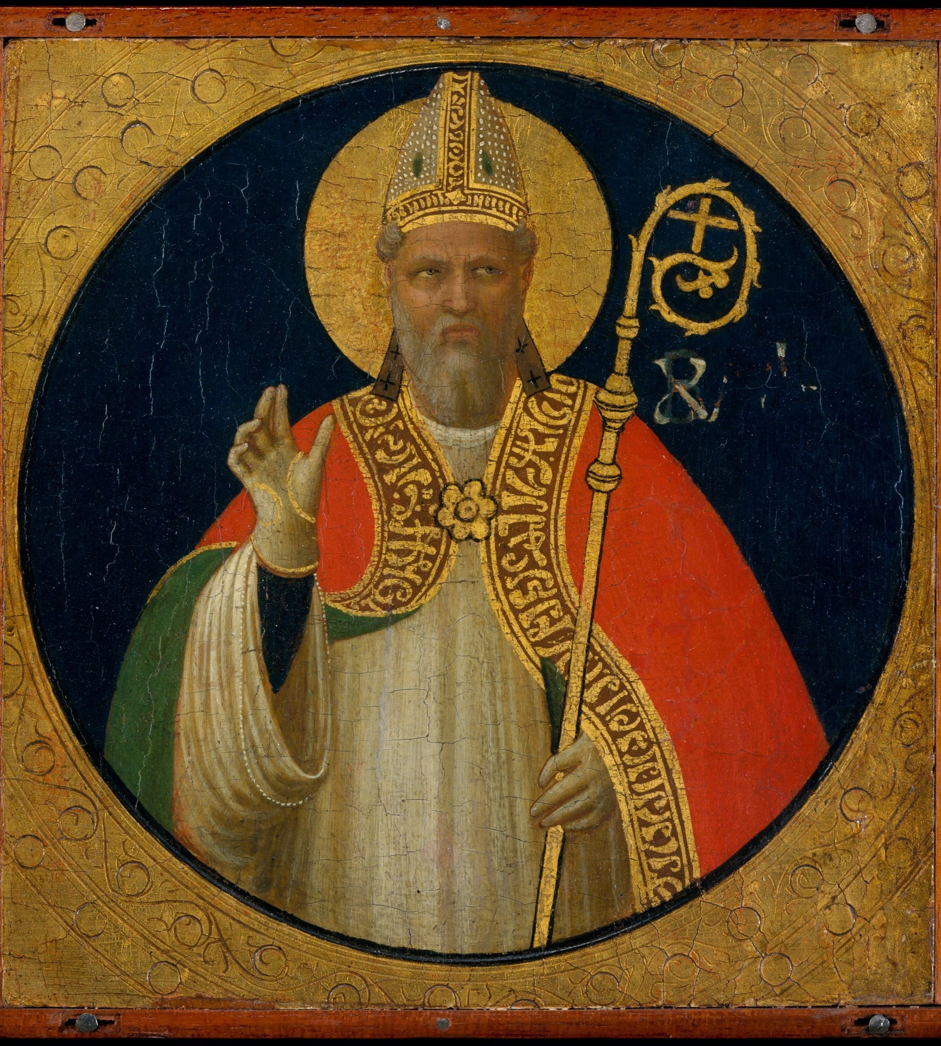 The tondo format (circle within a square panel) was used for devotional images; the deep lapis-like blue against gold creates a jewel-box effect typical of Fra Angelico's altarpiece panels