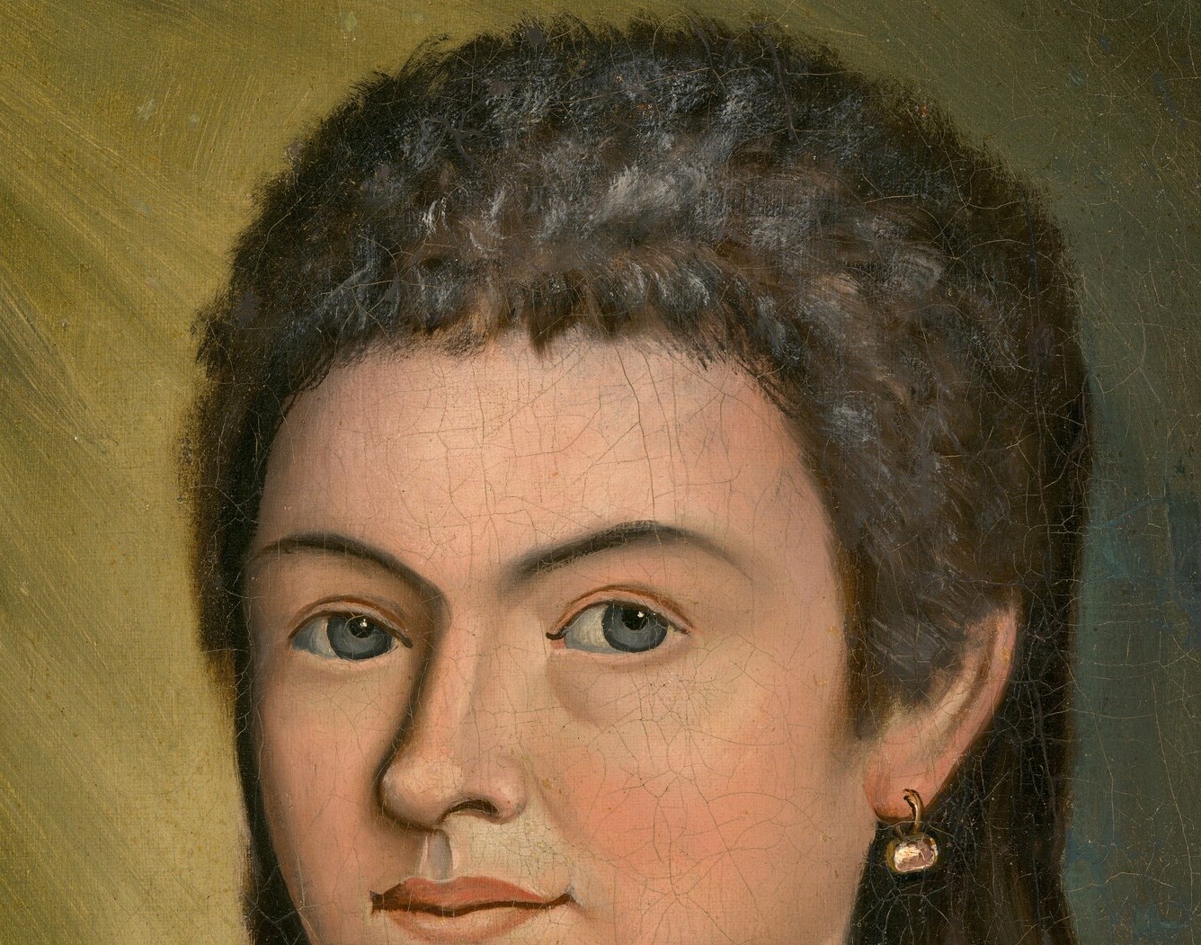 The texture and volume of her hair suggest a youthful vitality and contrast with her smooth skin.