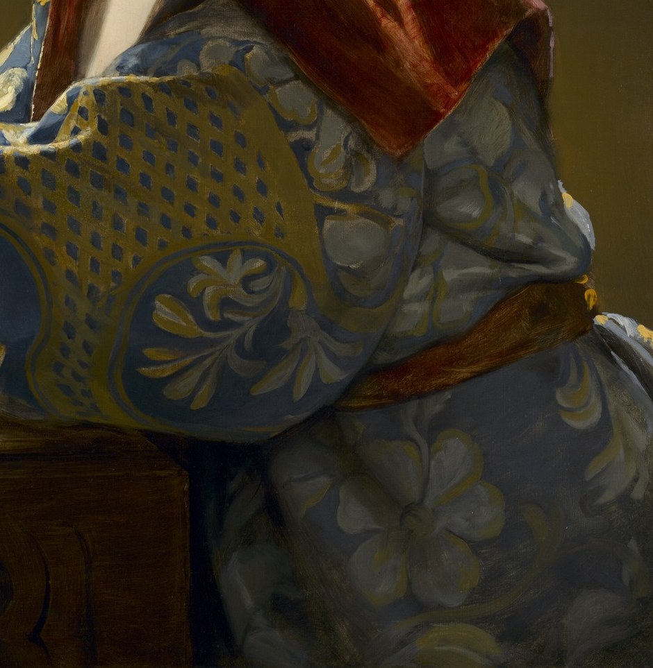 The patterned robe hints at a rich background.