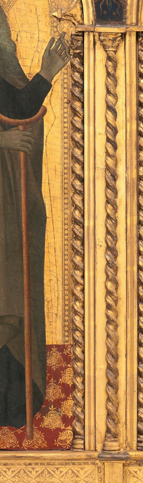 The simple wooden staff, a symbol of his pilgrimage and monastic life, grounds the figure.