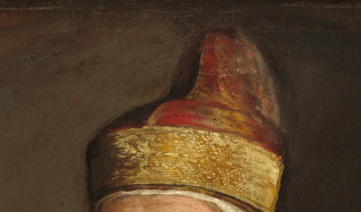 The tall red cap is the insignia of supreme Venetian office; its crimson matches the robe and anchors the power symbolism of the whole portrait.