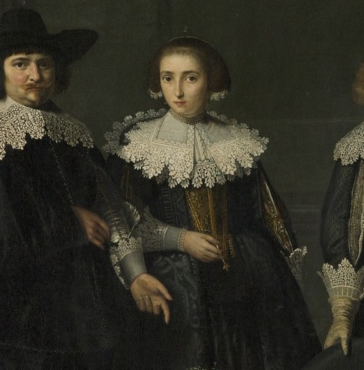 His wife Agatha wears elaborate clothing.