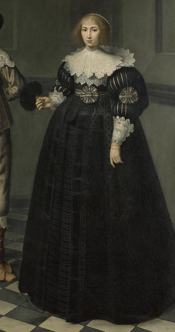 Her rich gown signifies the family's wealth.