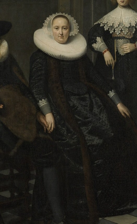 Look at her stiff white ruff and jewels.