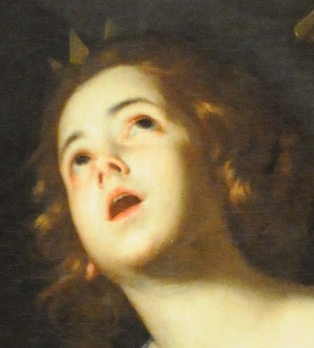 She looks up, in a moment of spiritual rapture.