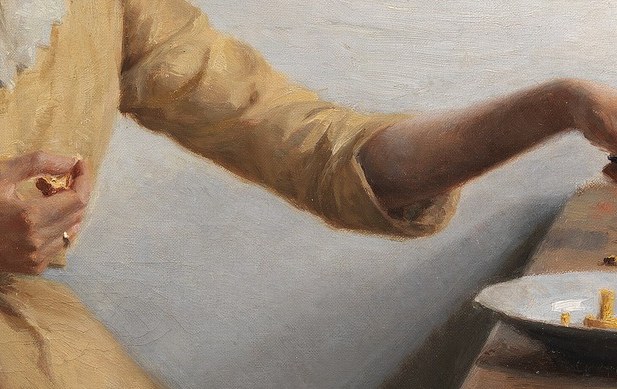 The delicate movement of her fingers as she cuts the mushrooms highlights her careful preparation.
