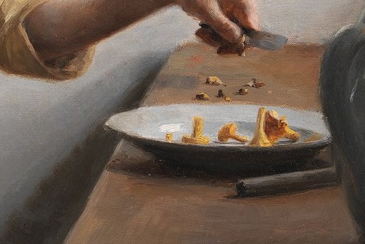 She cuts chanterelle mushrooms, a symbol of nature's bounty.